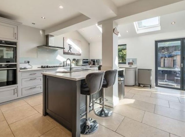 The beautifully designed kitchen benefits from two integrated dishwashers, Neff extractor hood complementing a large 5 burner gas hob and two top of the range self-cleaning Neff ovens.
