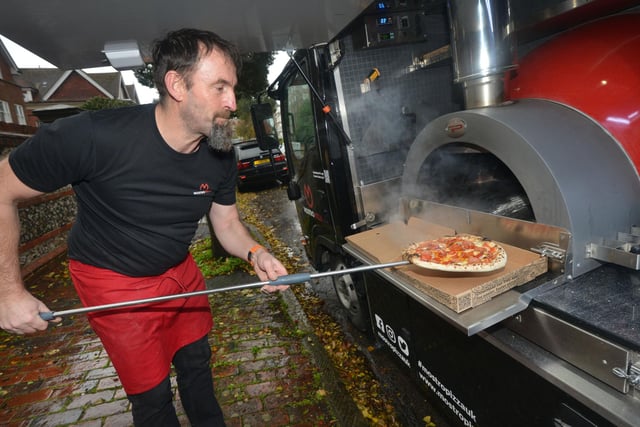Rob Impey taking a pizza out of the oven