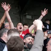 Crawley Town players celebrate in the stands after Saturday's historic win | Picture: Dov Friedmann