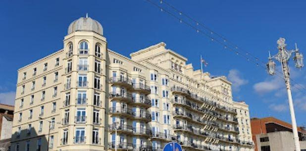A luxurious seafront hotel with elegant rooms and stunning views, offering impeccable service