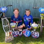 Poppy and Holly Bishop with their bikes and trophies