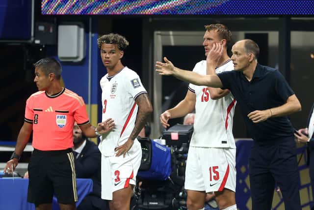 Nico O'Reilly and Dan Burn stand on the touchline while Thomas Tuchel gestures during the semi-final between England and Argentina (Photo by Richard Pelham/Getty Images)