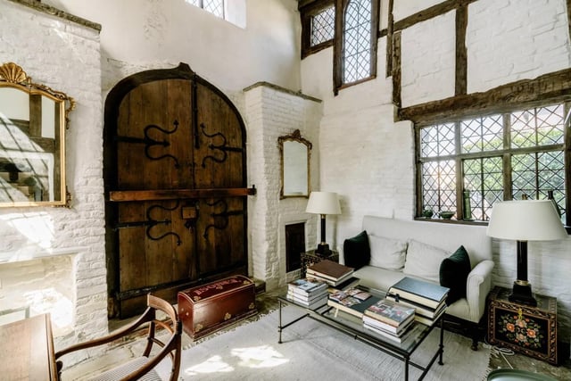 Solid oak carved double doors open to a vaulted ‘guard room’, which is being used as a study