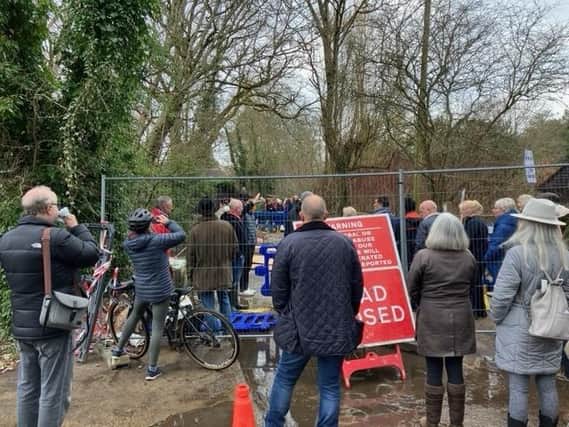 A protest has been held in a South Downs village amid the prolonged closure of a key road.