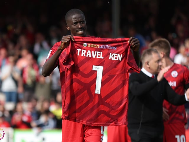 Panutche Camara holds a shirt up for club legend Ken Blackmore after the Northampton win