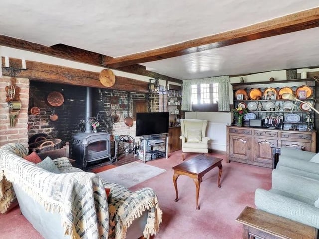 The drawing room has a working woodburner fitted into the inglenook