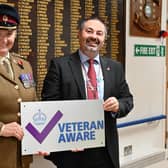 Lt.Col. Tania Cubison, medical director with James Lowell, chief executive officer, in front of The Guinea Pig Club Roll of Honour board at Queen Victoria Hospital, East Grinstead
