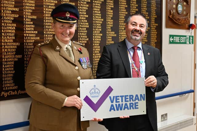 Lt.Col. Tania Cubison, medical director with James Lowell, chief executive officer, in front of The Guinea Pig Club Roll of Honour board at Queen Victoria Hospital, East Grinstead