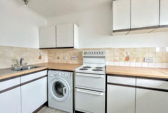 The kitchen has a work surface, wall and base units, oven and hob, sink and drainer, plumbing for washing machine, and space for fridge freezer.