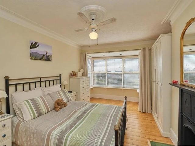 To the first floor there are four bedrooms, with the master room enjoying picturesque rooftop views and charming original cast iron fireplace.