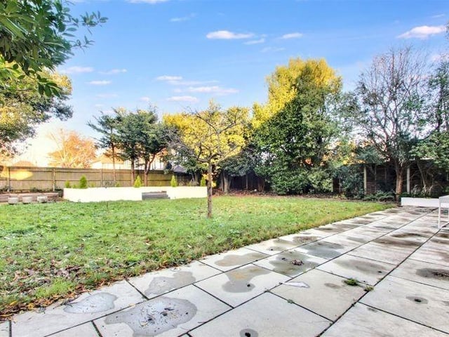 The back garden is mainly laid to lawn with established borders, a patio area and a variety of mature trees and shrubs