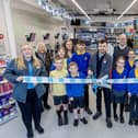 Pupils help cut the ribbon and declare the new Co-op store open