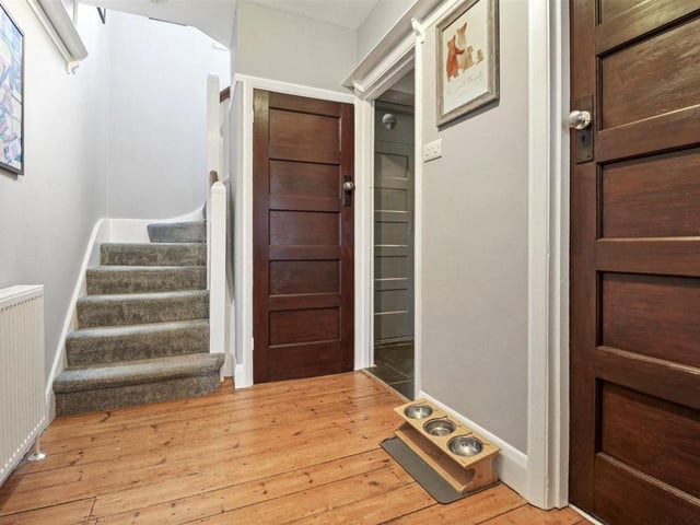 The charming hallway is complemented by original wood flooring
