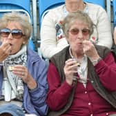 Two ladies enjoying a court-side snack