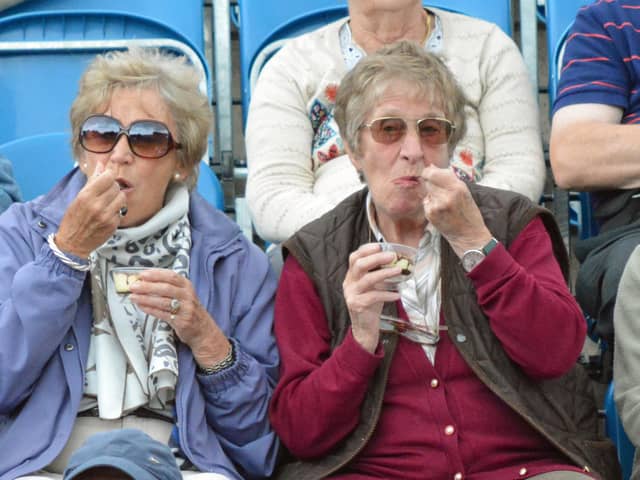 Two ladies enjoying a court-side snack
