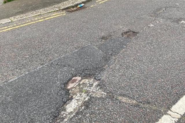 Badly damaged road surface in Clive Vale