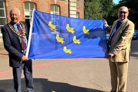Horsham District Council chairman David Skipp and vice chairman Nigel Emery prepare to raise the Sussex Day flag