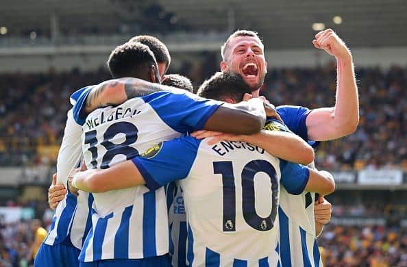 Adam Webster of Brighton & Hove Albion celebrates after team mate Solly March scored the team's fourth goal during the Premier League match at Wolves