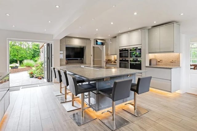 The contemporary kitchen sits centrally in the house and connects with the double aspect dining room and lounge