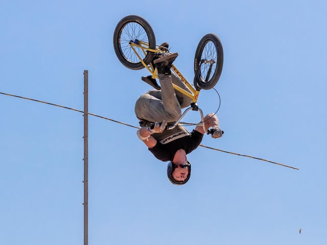 A BMX rider backflips through the air. Photo: Michael John Reed.