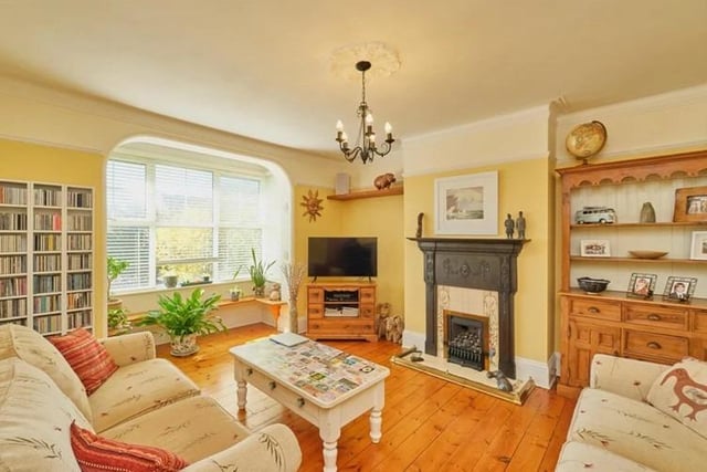 The living room is bright and airy, boasting wooden flooring, gas fire with stunning original cast iron surround, original picture rails and bay window.