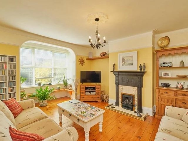 The living room is bright and airy, boasting wooden flooring, gas fire with stunning original cast iron surround, original picture rails and bay window.