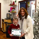 Gillian Keegan MP meets Stanley, aged 7, to award his certificate.
