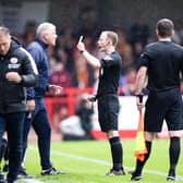 One of the Bradford City bench is booked at the Broadfield Stadium in the first game of the season.  Crawley Town manager, seen in the foreground, says the new measures for dissent and techncal area policing are 'too much'.. Picture: Eva Gilbert
