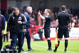 One of the Bradford City bench is booked at the Broadfield Stadium in the first game of the season.  Crawley Town manager, seen in the foreground, says the new measures for dissent and techncal area policing are 'too much'.. Picture: Eva Gilbert