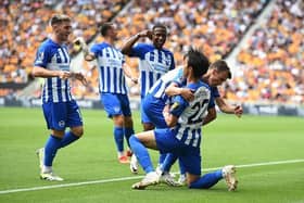 Kaoru Mitoma of Brighton & Hove Albion celebrates with teammates after scoring the team's first goal at Wolves