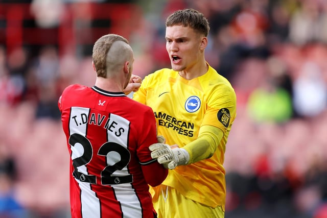 Tom Davies of Sheffield United clashes with Bart Verbruggen of Brighton & Hove Albion during the Premier League match between Sheffield United and Brighton & Hove Albion at Bramall Lane on February 18, 2024 in Sheffield, England. (Photo by Matt McNulty/Getty Images)