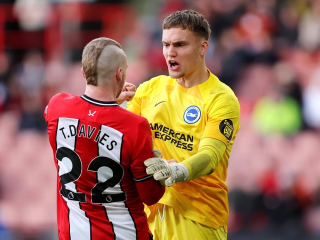 Tom Davies of Sheffield United clashes with Bart Verbruggen of Brighton & Hove Albion during the Premier League match between Sheffield United and Brighton & Hove Albion at Bramall Lane on February 18, 2024 in Sheffield, England. (Photo by Matt McNulty/Getty Images)