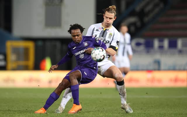Anderlecht's Percy Tau and Charleroi's Guillaume Gillet fight for the ball during a soccer match between Sporting Charleroi and RSCA Anderlecht, Friday 18 December 2020 in Charleroi, on day 15 of the 'Jupiler Pro League' first division of the Belgian championship.