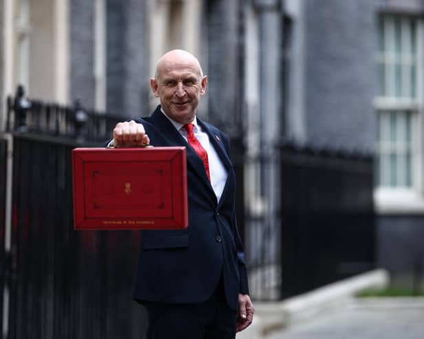 Britain's Chancellor of the Exchequer John Healey poses with the Budget Box as he leaves 11 Downing Street in central London on October 28, 2026, before presenting the government's annual budget to parliament. (Photo by Henry NICHOLLS / AFP via Getty Images)