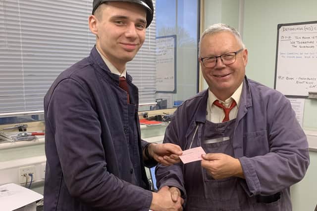 Ben Gray being passed his driver’s card by Bluebell Railway inspector Chris Suitters  at Sheffield Park. Picture: Tim Gray