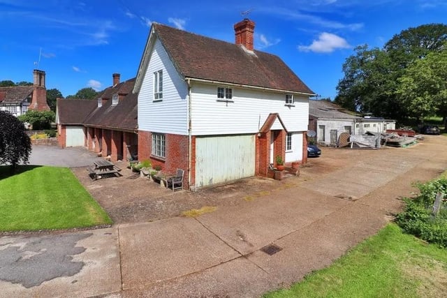A three-bedroom flat with a garage is at the far end of the outbuilding