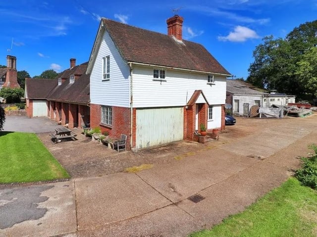 A three-bedroom flat with a garage is at the far end of the outbuilding