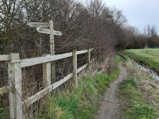 The north side is narrow but it is clearly marked as a public footpath as you walk along it