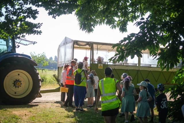 Children boarding the tractor and trailer to be given a tour of the estate