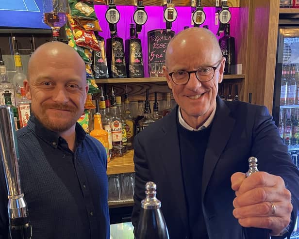 Callum Smith-Warren with Nick Gibb behind the bar at the Punch &Judy.