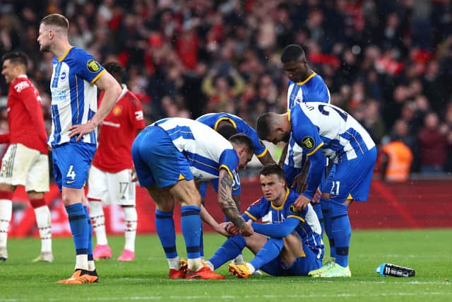 Solly March is consoled by team-mates following Brighton & Hove Albion's penalty shootout defeat to Manchester United in the FA Cup semi-finals. Picture by Clive Rose/Getty Images