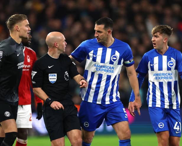 Lewis Dunk of Brighton & Hove Albion talks to Referee, Anthony Taylor during the Premier League match between Nottingham Forest and Brighton & Hove Albion at City Ground on November 25, 2023 in Nottingham, England. (Photo by Eddie Keogh/Getty Images)