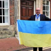 Horsham District Council vice chairman Nigel Emery with the Ukrainian national flag. Photo contributed