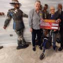 Kevin Grover and blind veteran dad Les presents cheque to military charity from Hill Barn Golf Club.