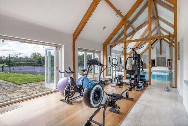 There is a gym next to the indoor pool with doors that open onto the garden