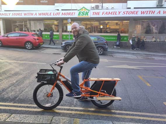 Volunteer delivery rider on a brand new electric cargo bike