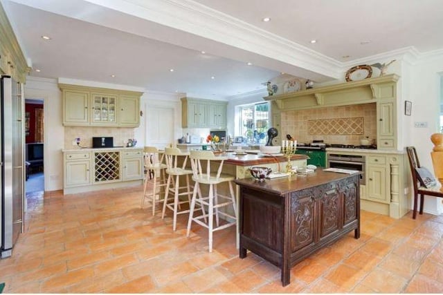 The wonderful kitchen and dining room has bespoke solid wood Clive Christian cabinetry and an Iroko-topped central island by Clive Christian, with granite worktops and a range of high-end integrated appliances including a two-oven oil-fired Aga