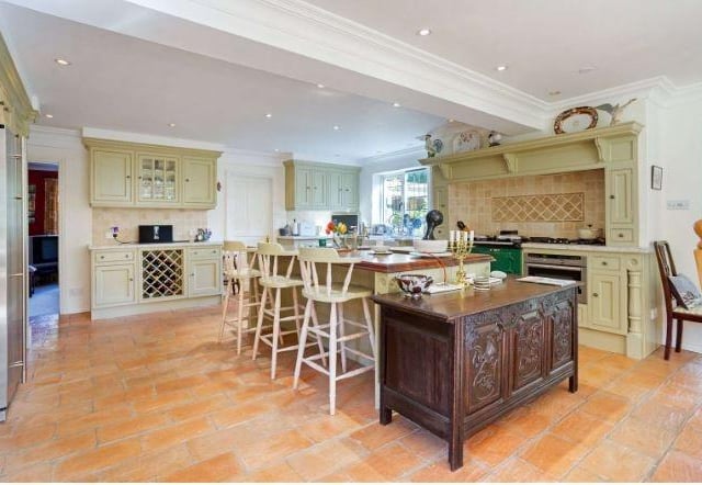 The wonderful kitchen and dining room has bespoke solid wood Clive Christian cabinetry and an Iroko-topped central island by Clive Christian, with granite worktops and a range of high-end integrated appliances including a two-oven oil-fired Aga