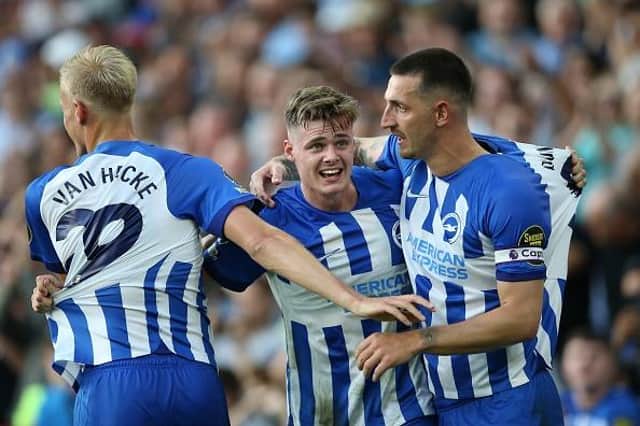 Evan Ferguson of Brighton & Hove Albion celebrates with Lewis Dunk and Jan Paul van Hecke after scoring the team's second goal against Newcastle