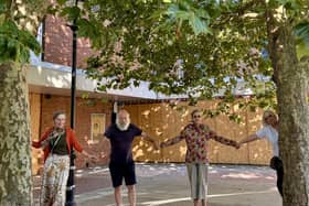 Burgess hill councillors and local residents join hands under the trees that are due to be chopped down outside Martlets shopping centre